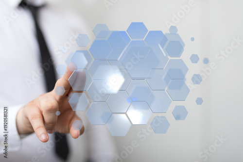 Hand touching digital hexag...