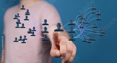 Fotografie Hand pointing at a digital network of people