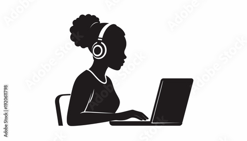 Woman working on laptop with headphones on, focused on task.