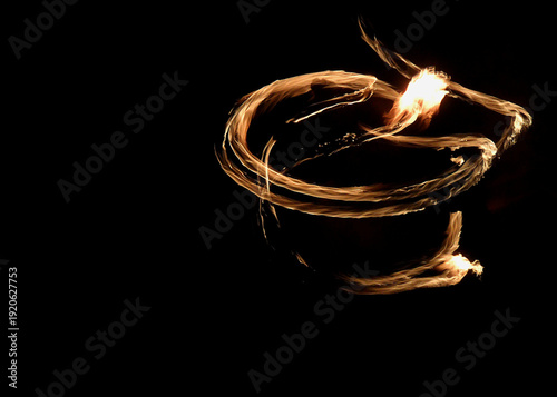 Abstract fire light painting with circular motion on black background
