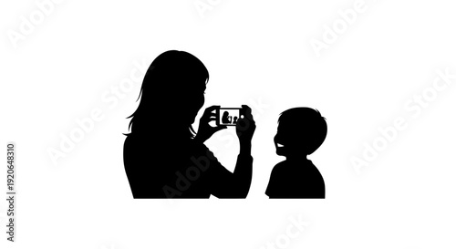 Silhouette of a woman taking a picture of a child.