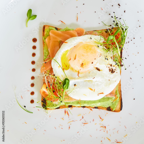 Premium avocado toast topped with a poached egg, smoked salmon, and fresh sprouts