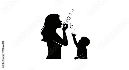 Mother and child blowing bubbles together in silhouette.
