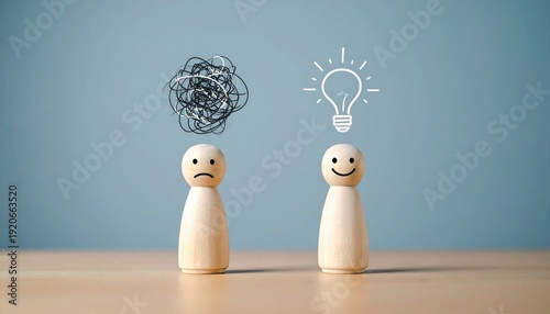 Wooden Figures Representing Confusion and Clarity with Scribble and Light Bulb Symbols
