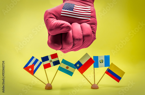 United States fist with flag on hand hovering over various Latin American country flags, conceptualizing geopolitical pressure, diplomatic influence, and sanctions