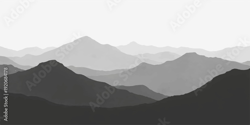 A misty blue mountain range silhouette unfolds under a morning sky where clouds and fog drift over snow peaks and hills at sunrise, creating a serene nature landscape view of the valley