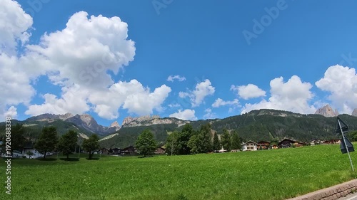 Summer Day In The Italian Dolomite, Canazei's Majestic Mountain Under Blue Sky in Italy, Movement View from the Road