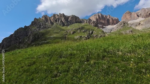 Moving View of Summer Day In The Italian Dolomite, Canazei's Majestic Mountain Under Blue Sky, Italy