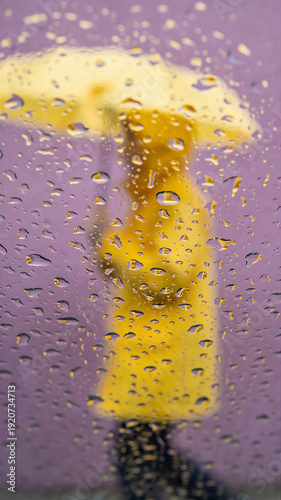 Wallpaper Mural Woman in yellow raincoat holding matching umbrella walks in spring rain through water-streaked window. Vernal equinox weather with blurred purple backdrop symbolizing seasonal renewal and fresh Torontodigital.ca