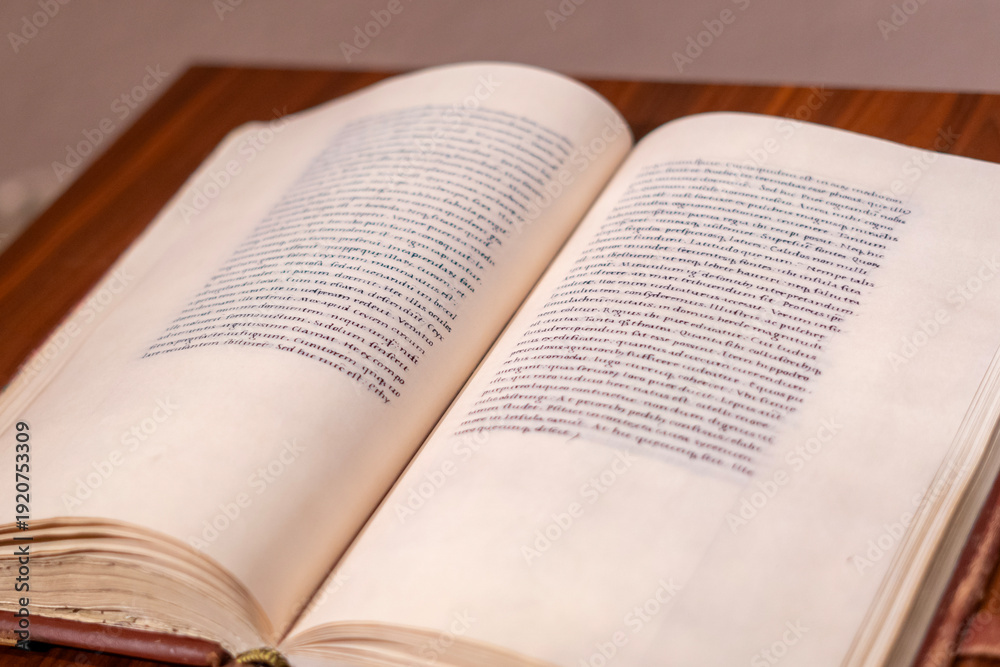 Fototapeta premium Open antique book on wooden table with soft focus