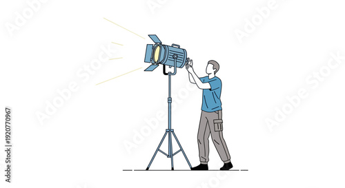 Man Adjusting Studio Lighting Equipment.