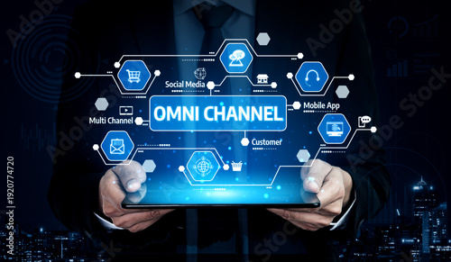 Wallpaper Mural A professional in a suit holds a digital tablet displaying an omni channel strategy, showcasing modern technology role in enhancing customer engagement and business growth. Tessel Torontodigital.ca