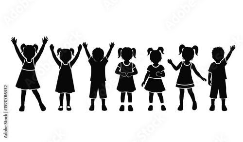 Silhouette of a group of happy children with their arms raised in celebration