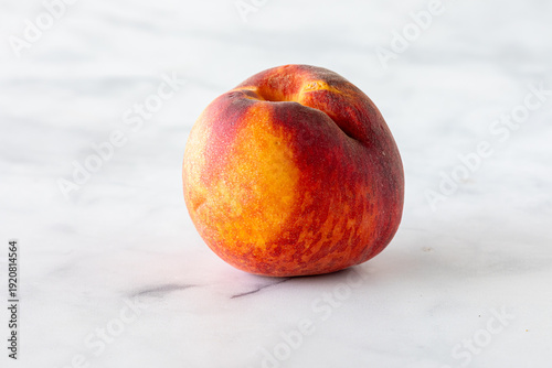 Tableau sur toile A close up of a fresh freestone peach against a light background.