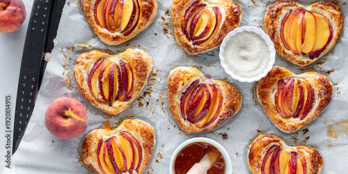Freshly baked heart shaped peach filled pastries, topped with jelly and sugar.