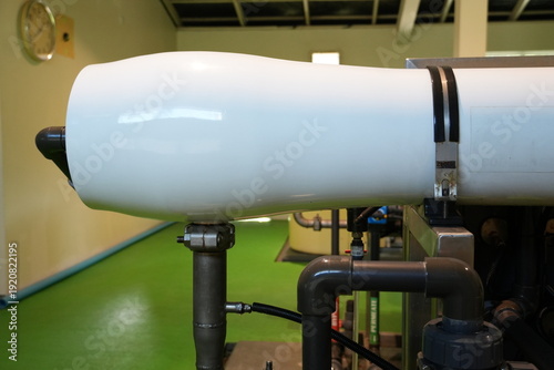 Canvastavla A large white cylindrical reverse osmosis membrane housing stands in an industrial treatment plant