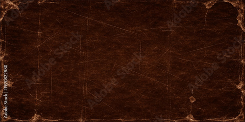 Aged grunge paper texture background featuring a dark brown vintage pattern with a rough weathered surface and antique material aesthetic for a dirty textured backdrop