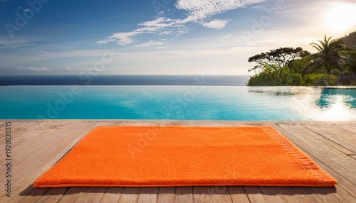 orange bath mat near tropical poolside with ocean view