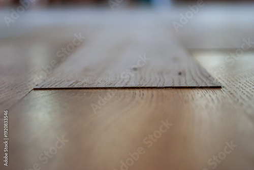 Fotografi parquet renovation close up with new wooden planks and uneven surface