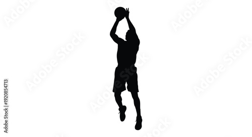 Basketball player in mid air shooting a hoop dark silhouette