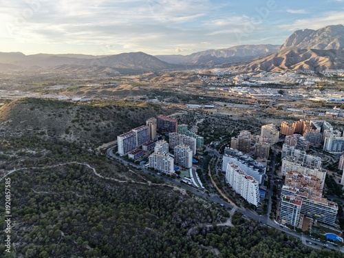 фотографія morning view of hillside housing, urban expansion observed from above on hilly t