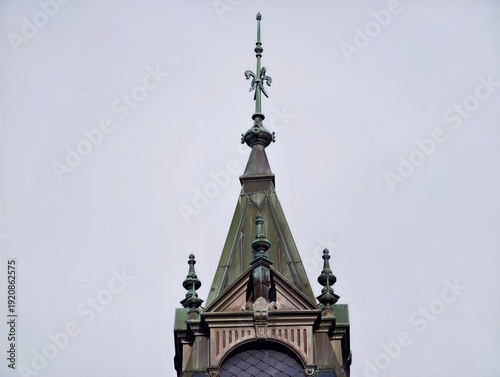 Gothic tower scene. Historical landmark silhouette with elaborate gothic metal accents under moody sky