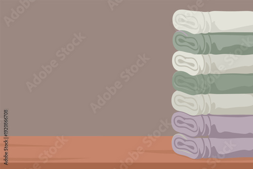 Stack of rolled up towels in pastel colors on wooden surface