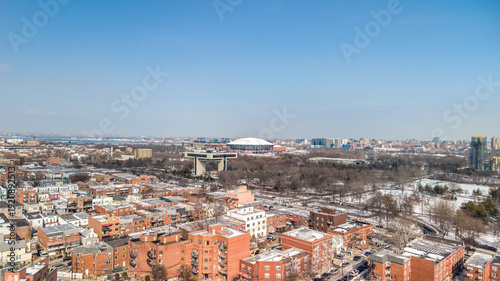 Queens, new york city, united states, showcasing a wide winter panorama of flushing meadows corona park, surrounding residential buildings, and iconic landmark structures under a clear blue sky