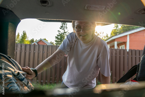 Wallpaper Mural Woman Loading Bag into Car Trunk Torontodigital.ca