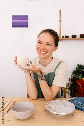 Expressive sculptor with handmade ceramic cup in atelier