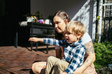 Mother and son talking in the backyard