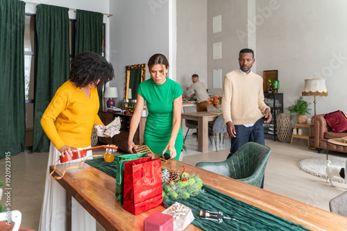 People clearing up the table after Christmas celebration