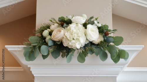 Elegant white floral arrangement with greenery on decorative shelf, perfect for home decor, weddings, and special occasions in soft interior setting