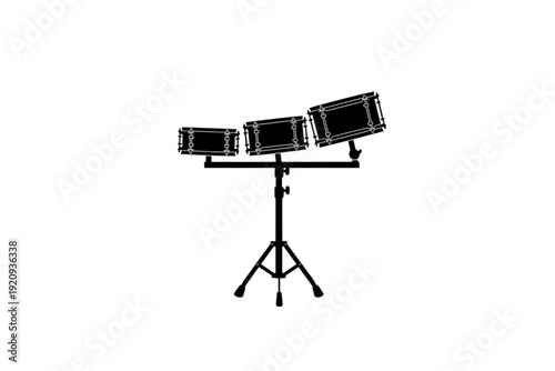 Rhythmic Trio: A monochromatic image showcasing a set of three drums, mounted on a stand, ready to create beats.
