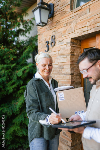 The postman delivers the parcel to the customer
