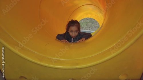 Upside down sliding at the playground. Slow motion.
