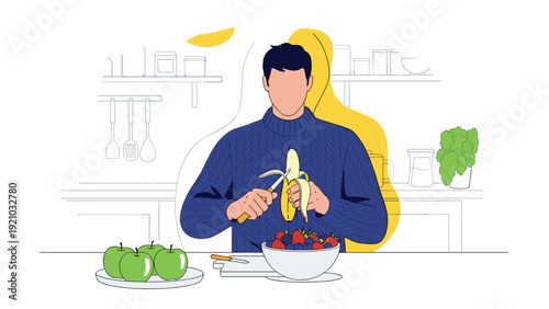 Young man in blue sweater preparing healthy fruit bowl by peeling banana in kitchen with apples and berries on white counter.