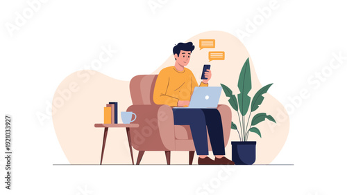 Relaxed man uses his laptop and smartphone for remote communication while sitting comfortably in a living room chair.