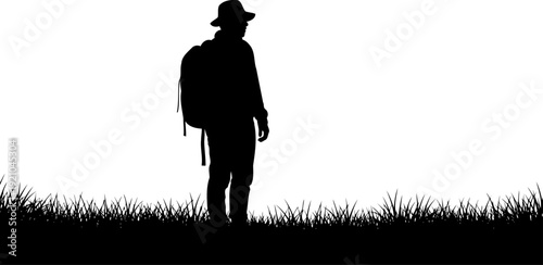 Hiker with backpack standing in tall grass