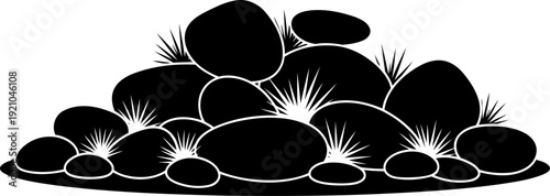 Rock pile silhouette with tufts of wild grass growing between stones