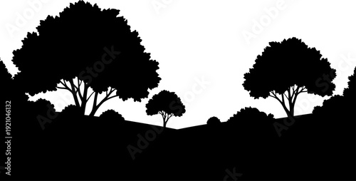Rolling countryside hills silhouette with scattered deciduous trees