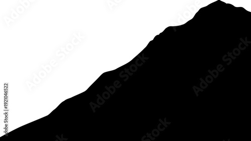 Steep mountain ridge silhouette against a bright horizon