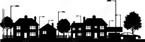 Suburban neighborhood street silhouette with houses and streetlights