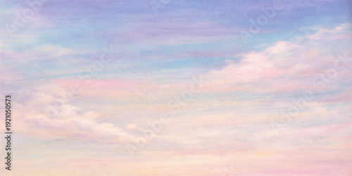 Beautiful colorful clouds float in a vibrant summer sky during a golden sunset nature landscape where bright sunlight creates an abstract orange and blue cloudscape at dusk