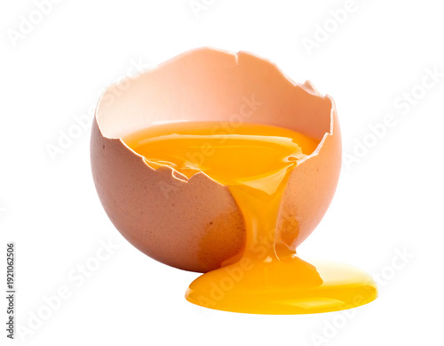 Broken egg with yolk spilling out a close-up shot on white background.
