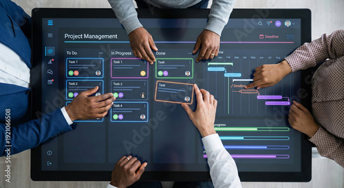 Diverse business team collaborating on project management board using interactive digital touch screen table top