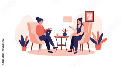 Two women engaged in a professional or personal conversation while sitting in comfortable armchairs with a laptop and coffee.