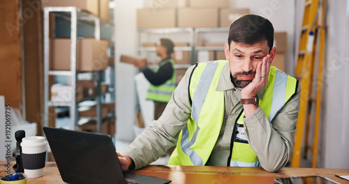 Foto Ecommerce, think and bored man in warehouse for supply chain, distribution or planning with laptop