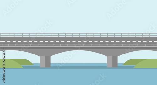 Modern concrete bridge spanning across blue water with green banks