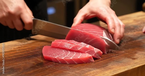 Wallpaper Mural Chef skillfully slicing fresh tuna on a wooden cutting board in a vibrant kitchen setting Torontodigital.ca